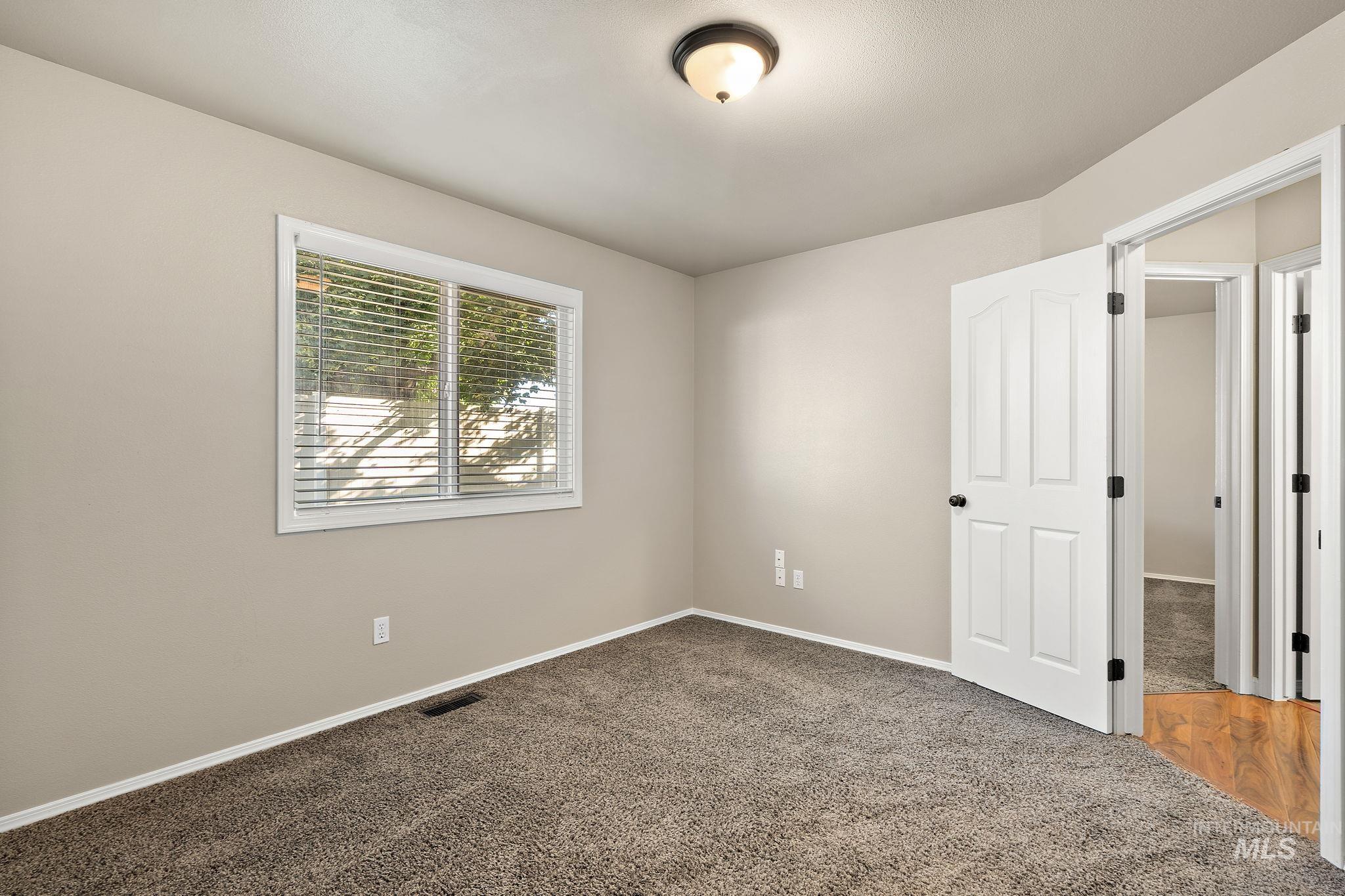 Unfurnished bedroom featuring carpet and baseboards