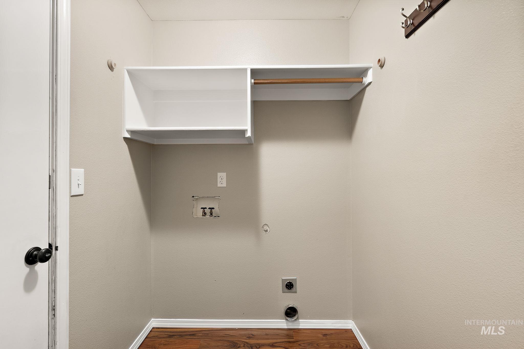 Laundry area featuring hookup for a gas dryer, dark wood-style flooring, hookup for a washing machine, and electric dryer hookup