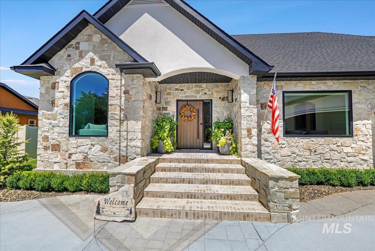 View of exterior entry featuring stone siding