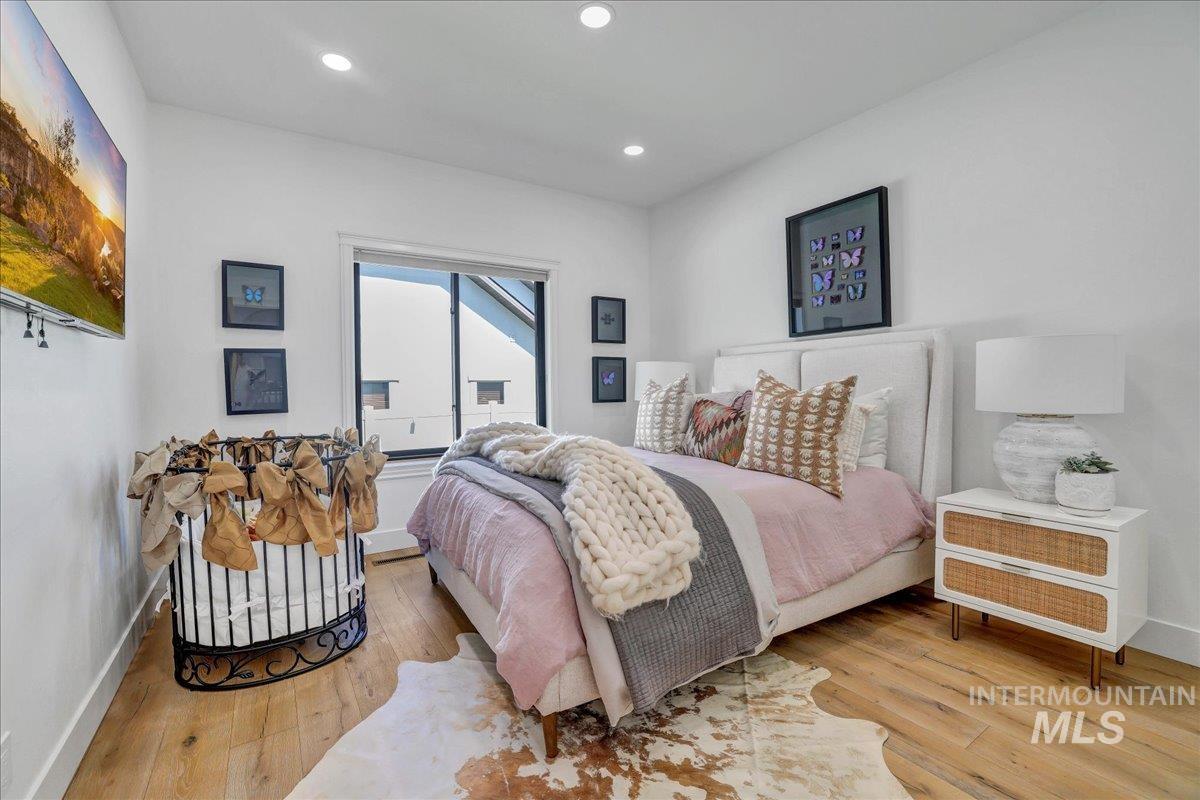 Bedroom featuring hardwood / wood-style flooring and recessed lighting