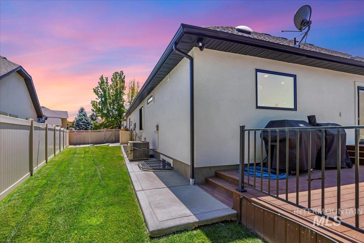 Back of house featuring stucco siding, a fenced backyard, and a patio