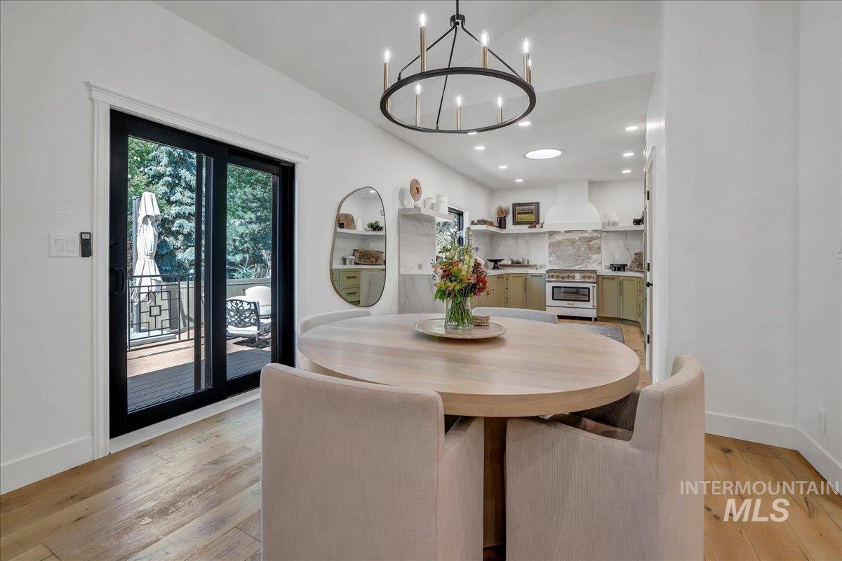 Dining room with recessed lighting, a chandelier, and light wood-style floors