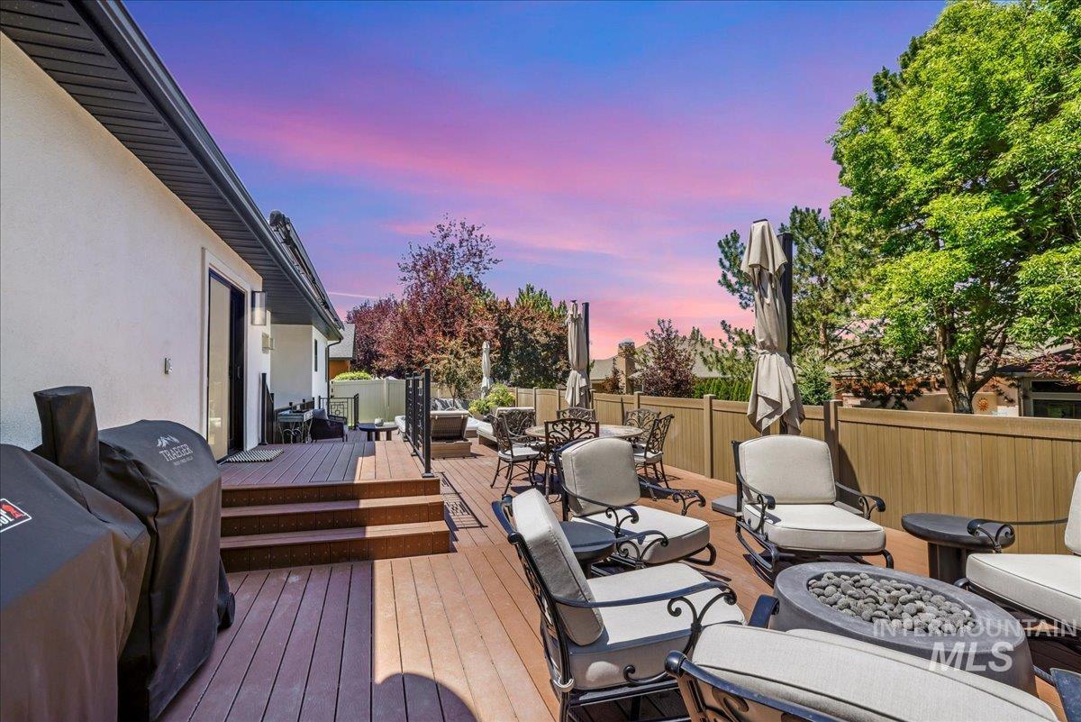 Deck featuring outdoor dining area and an outdoor living space with a fire pit