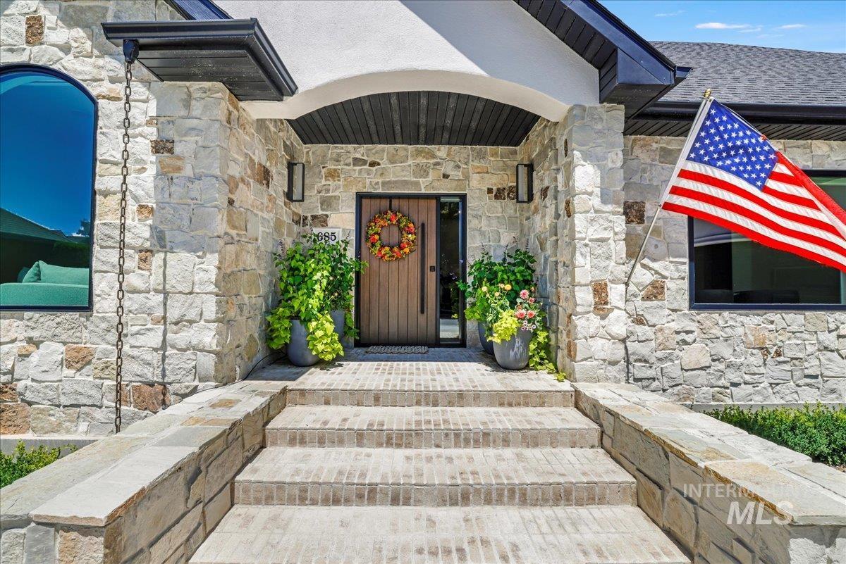 Entrance to property with stone siding