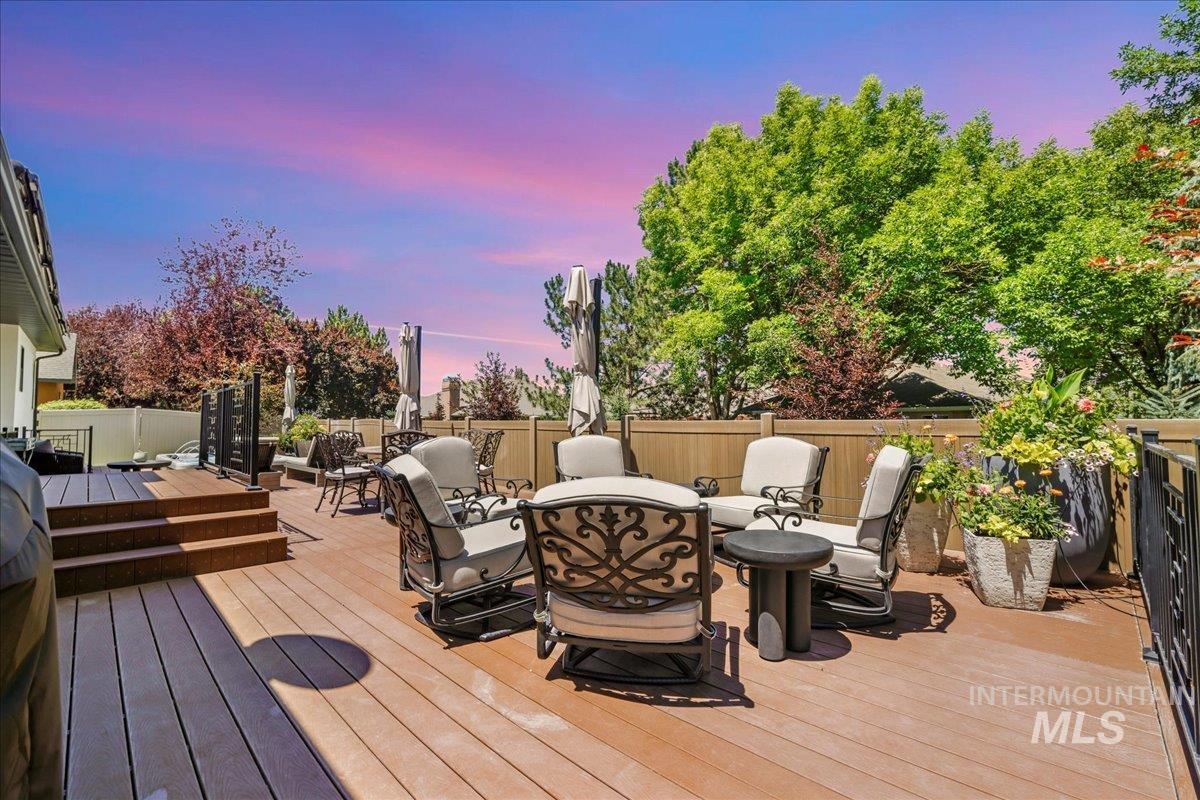 Wooden terrace featuring a fenced backyard and outdoor dining area