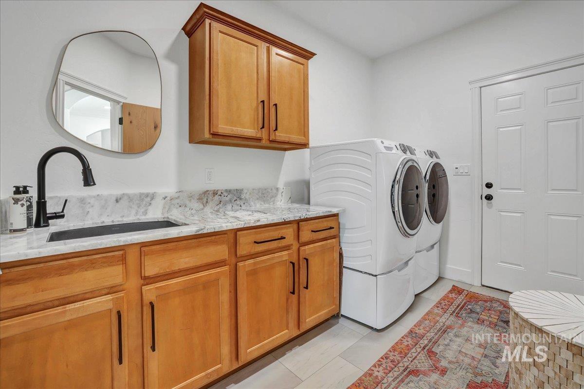 Laundry area featuring cabinet space and washer and dryer