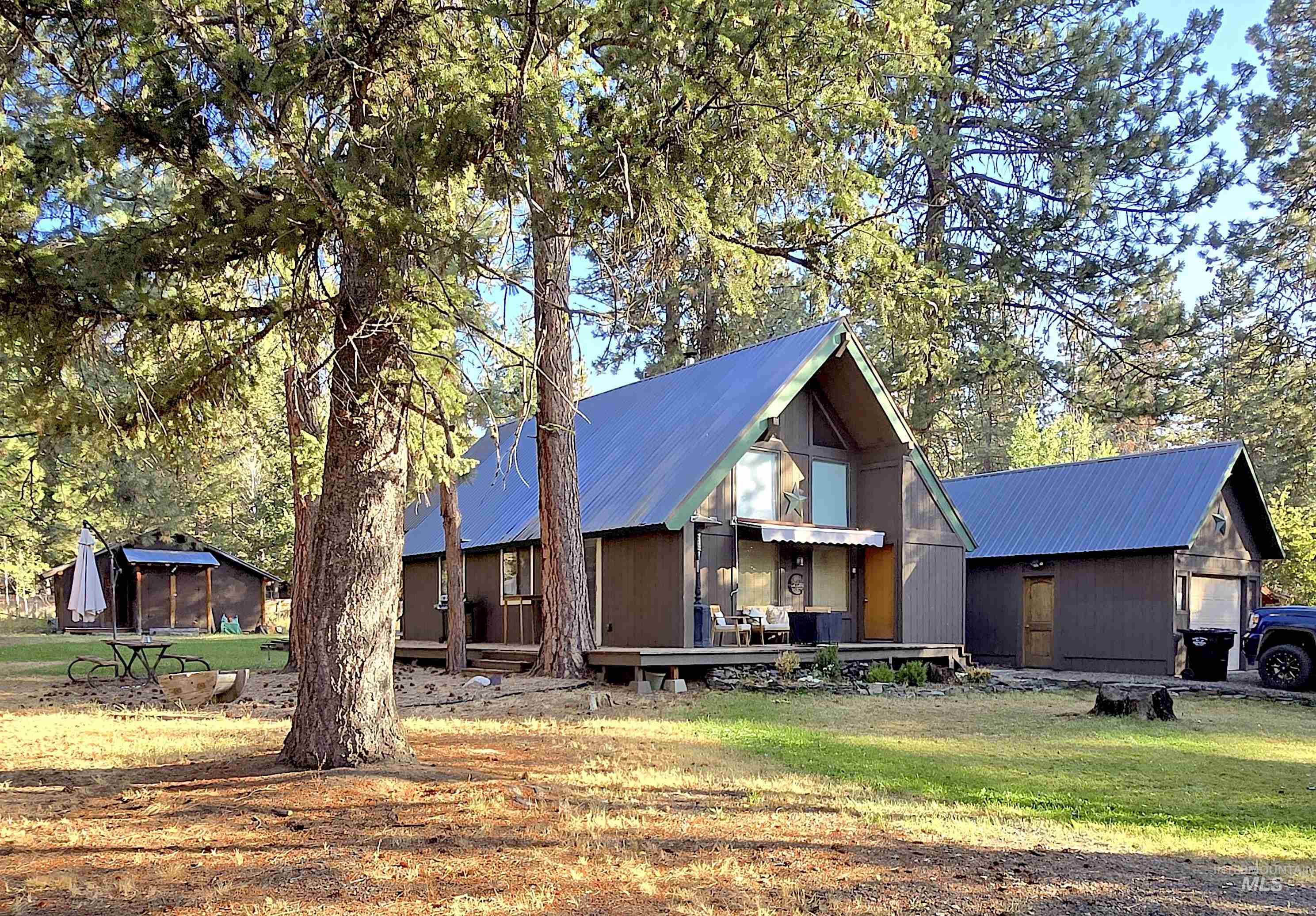 View of front of house with a metal roof and a front yard