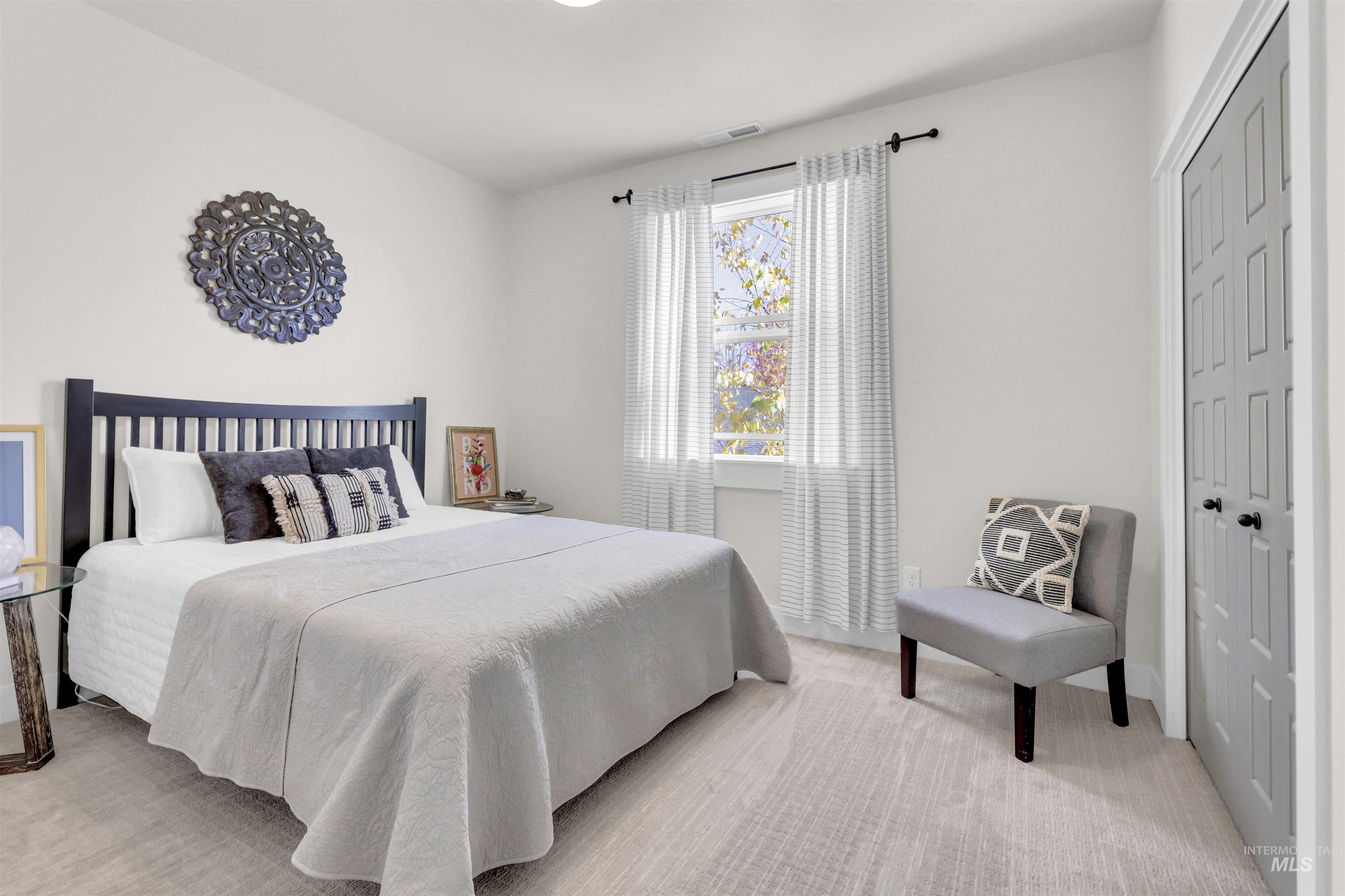 Bedroom with light carpet and a closet