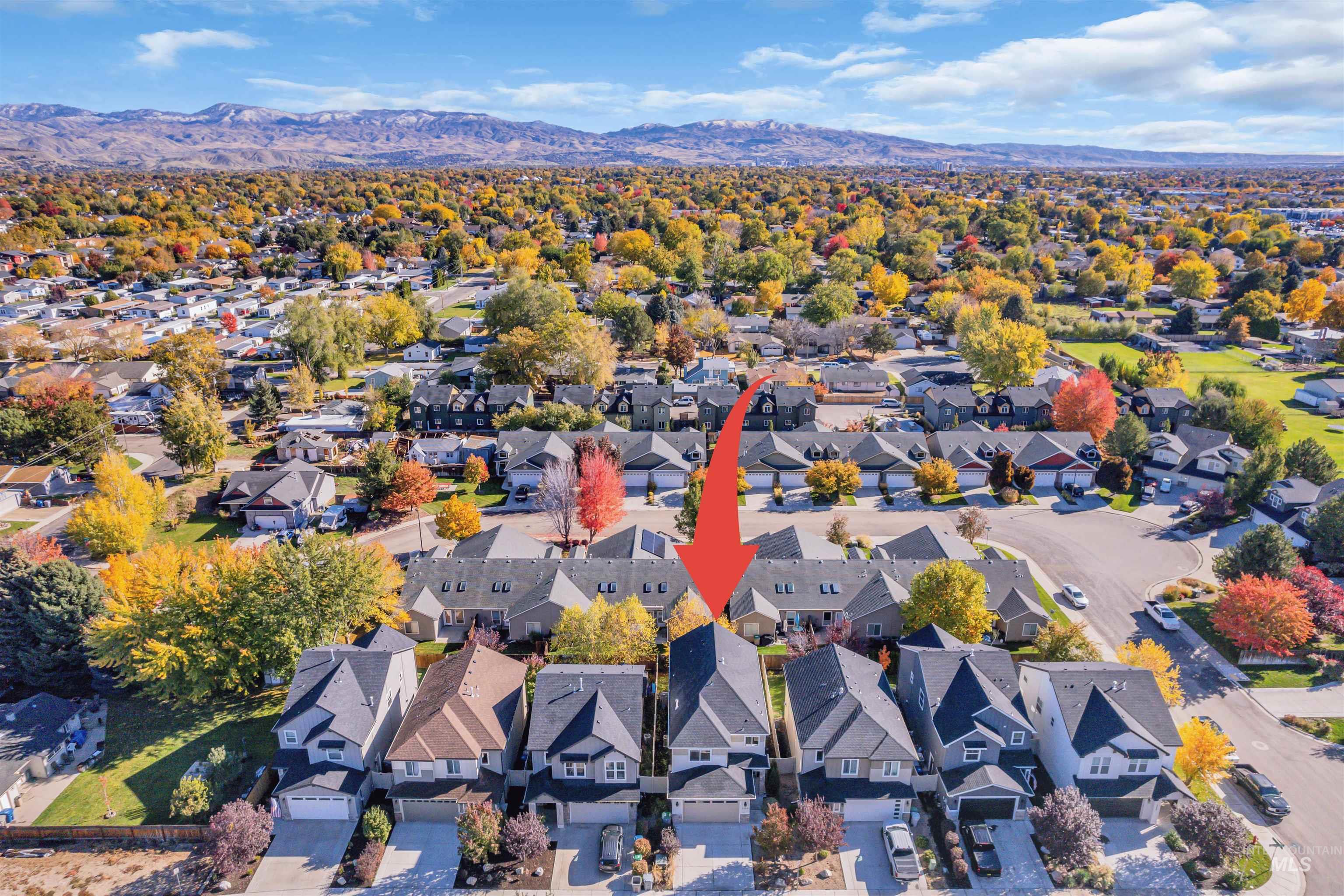 Aerial view of residential area featuring a mountainous background