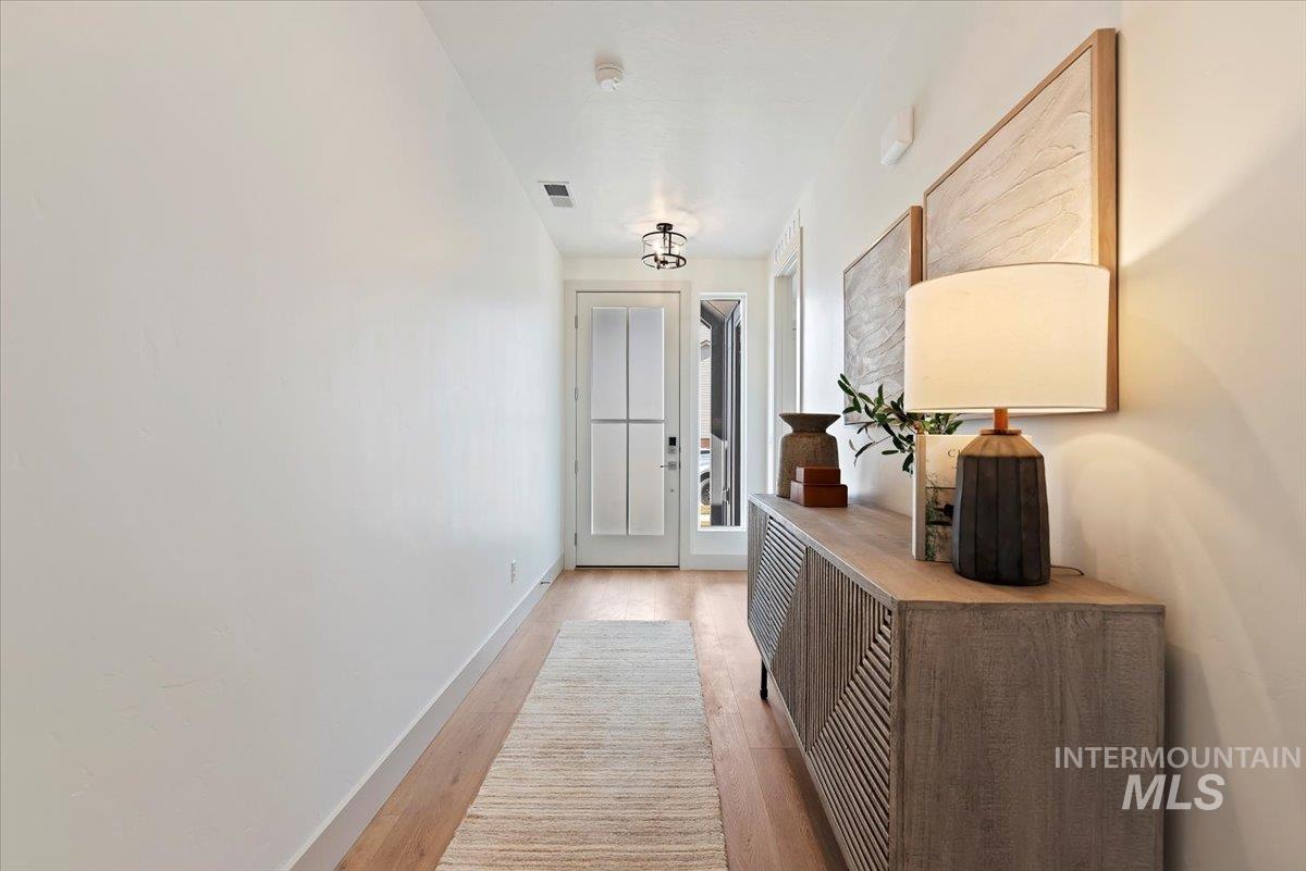 Hall featuring baseboards and light wood-type flooring