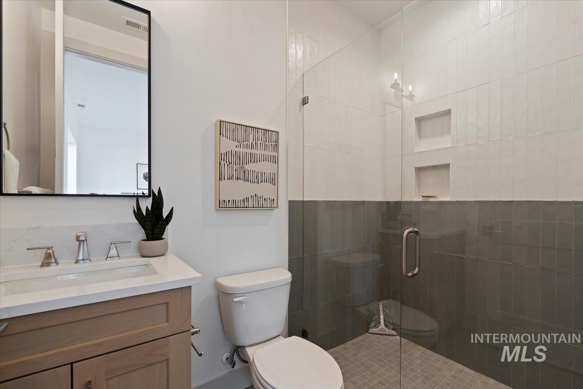 Bathroom featuring a stall shower and vanity