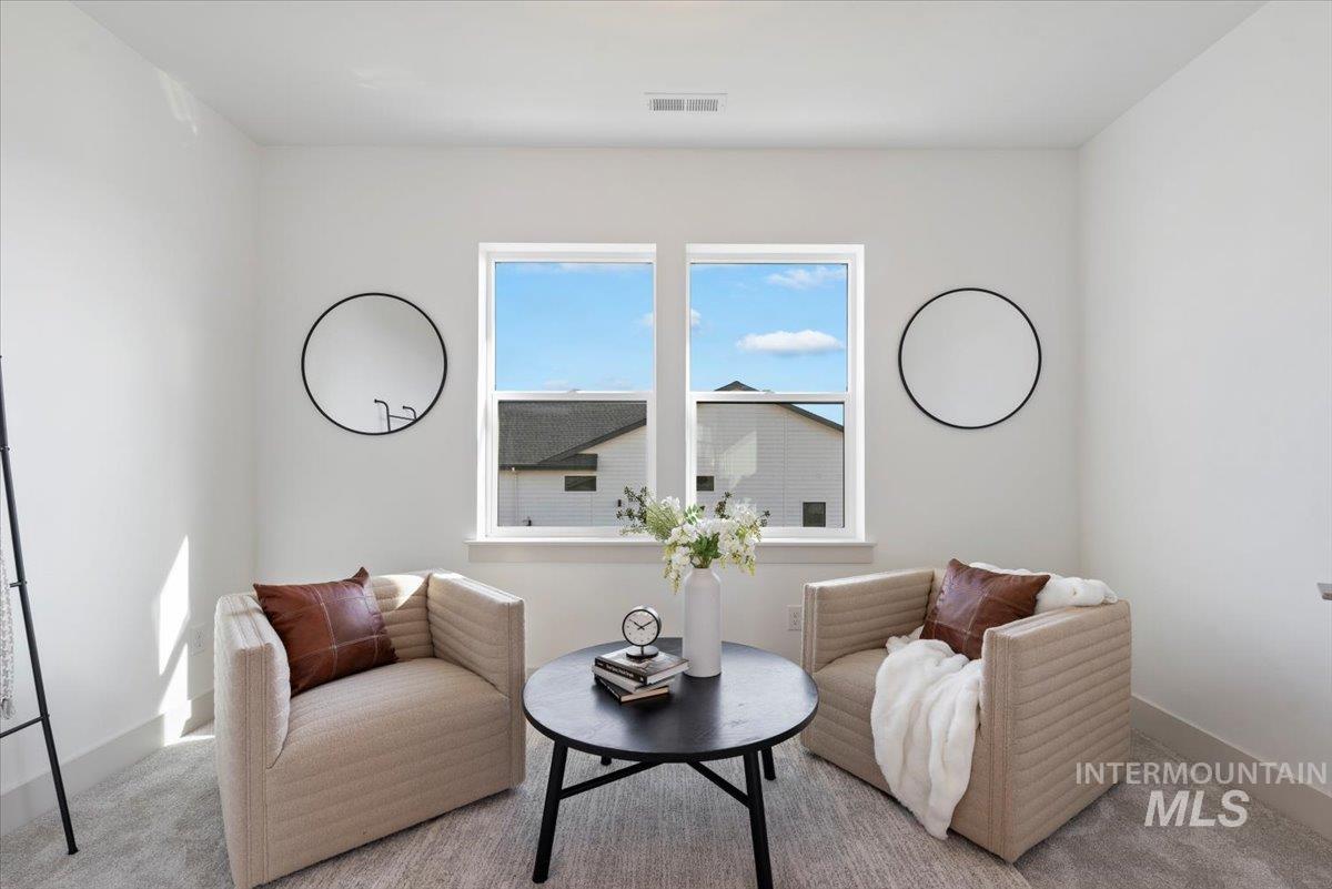 Sitting room featuring carpet floors and baseboards