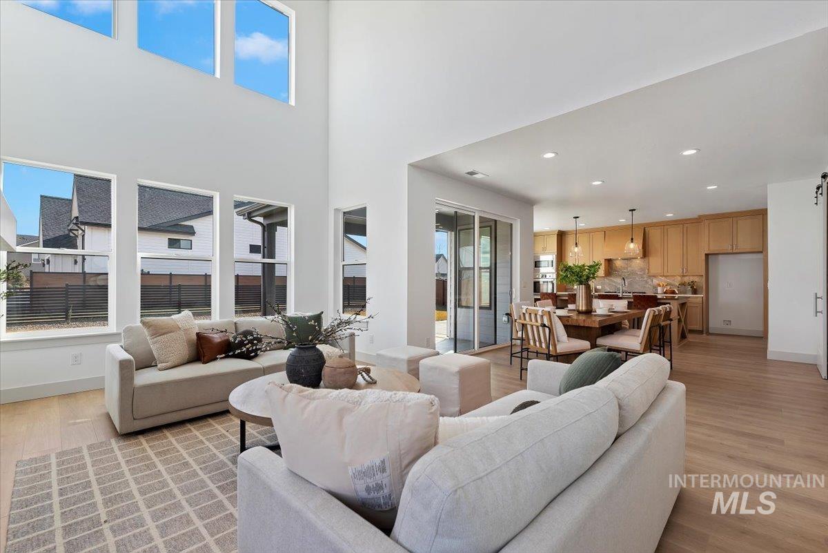 Living area with light wood-style flooring and recessed lighting