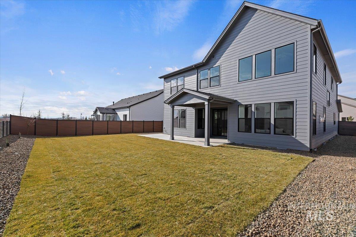 Rear view of house with a patio and a fenced backyard