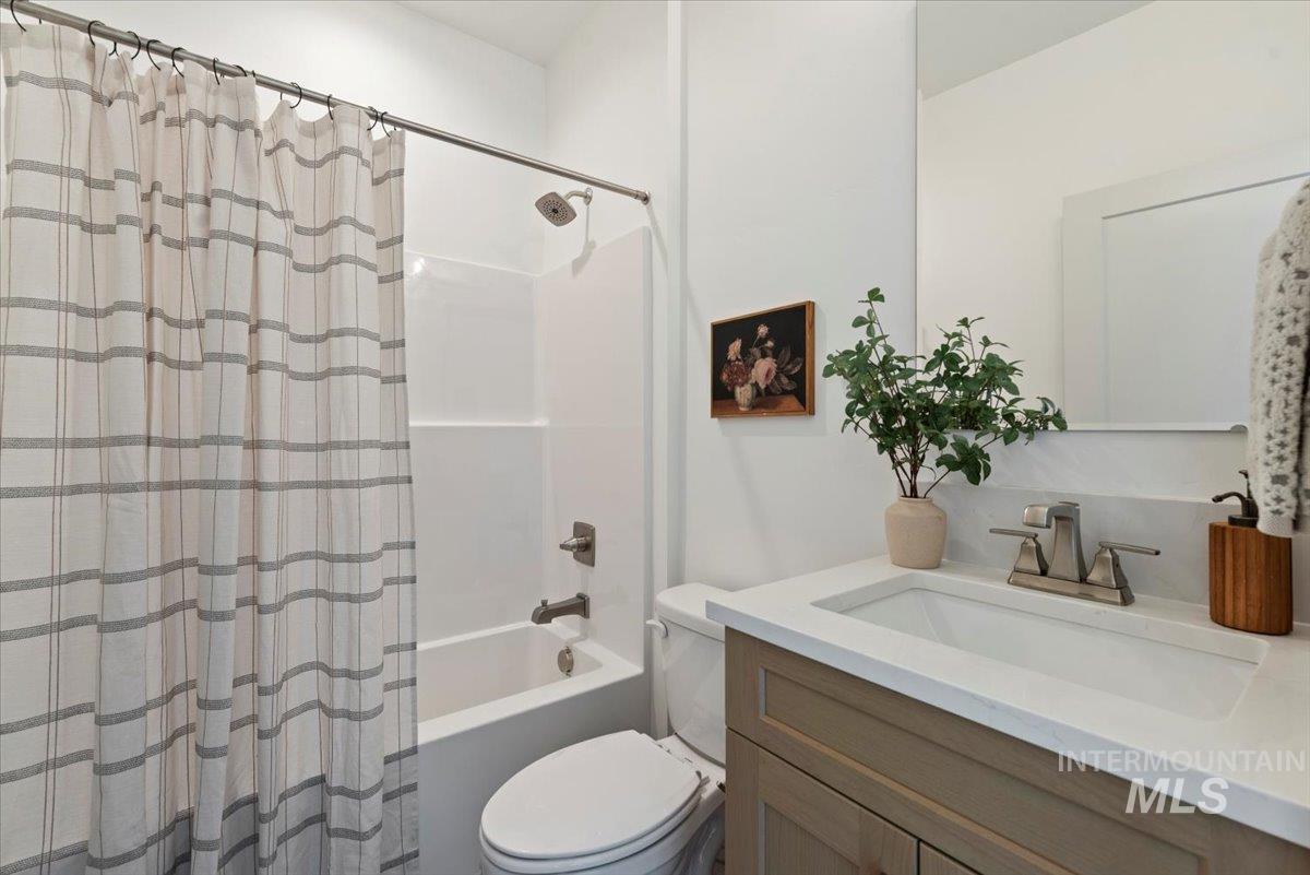 Bathroom with vanity and shower / bathtub combination with curtain