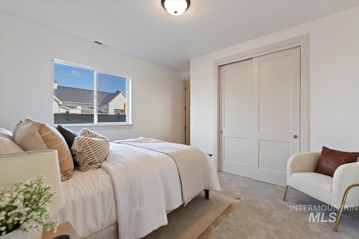 Bedroom featuring carpet floors and a closet