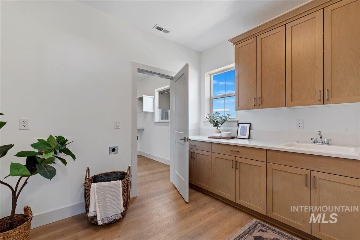 Kitchen featuring baseboards and light wood finished floors