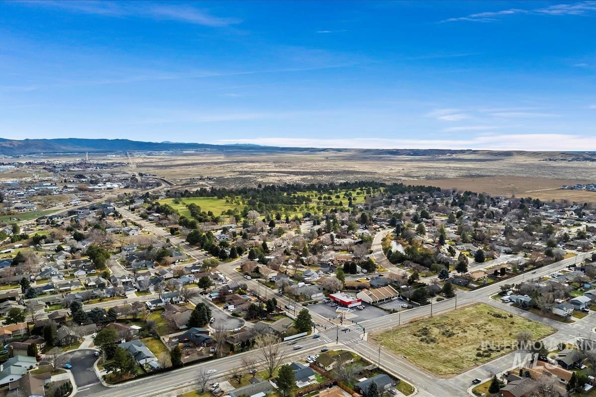 View of property location featuring nearby suburban area and a mountain backdrop