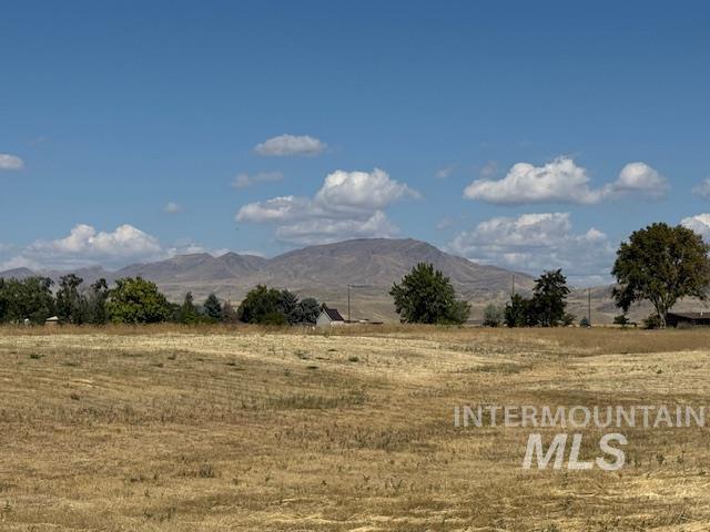 View of mountain backdrop featuring rural landscape