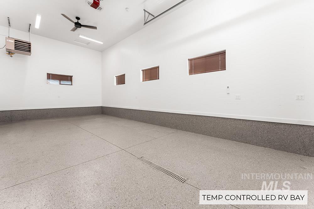 Garage with a heating unit and ceiling fan