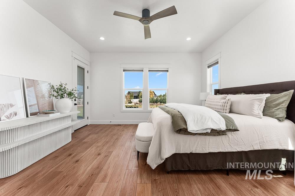 Bedroom with wood finished floors, recessed lighting, a ceiling fan, and access to exterior
