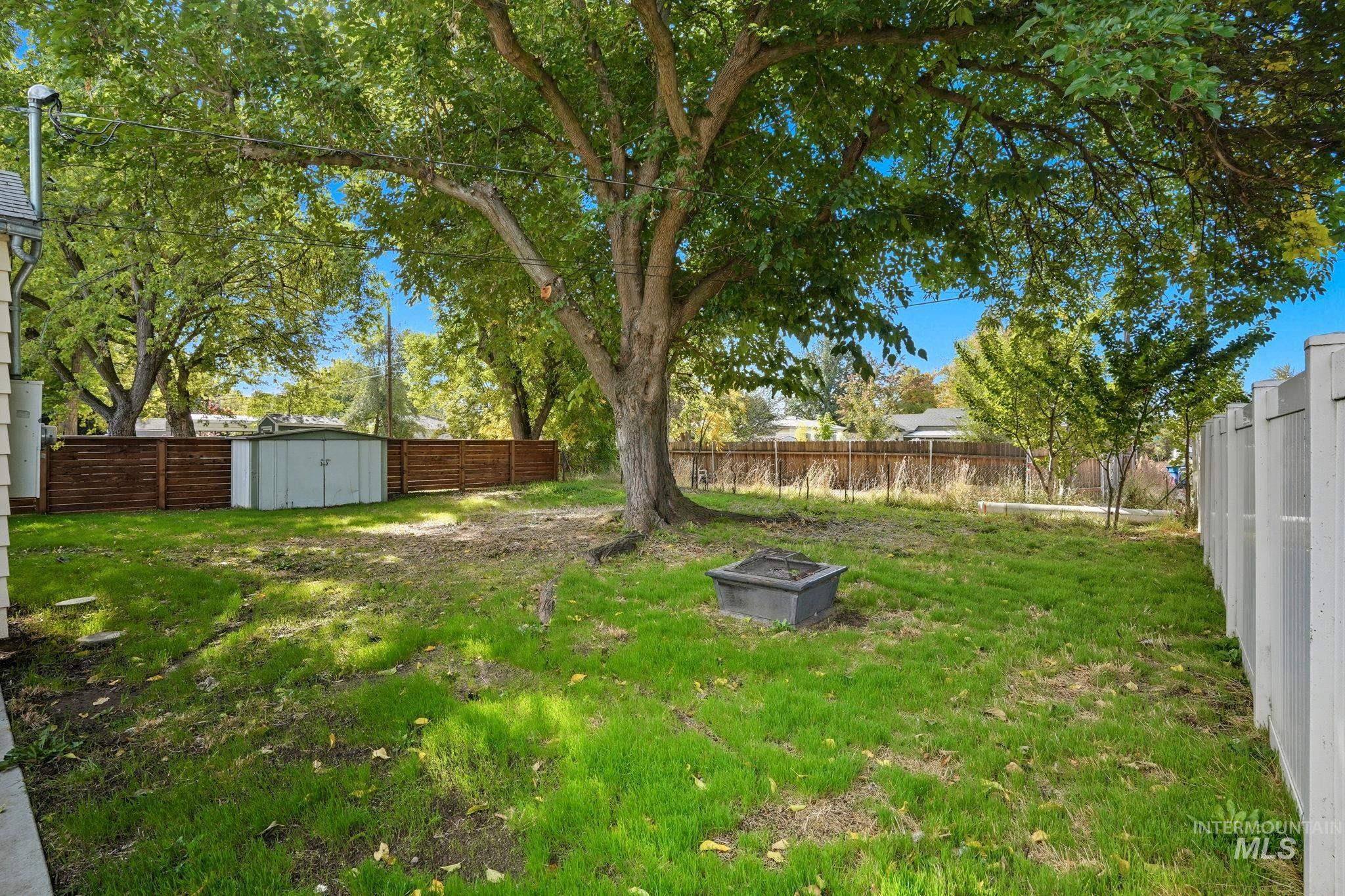 Fenced backyard with a shed
