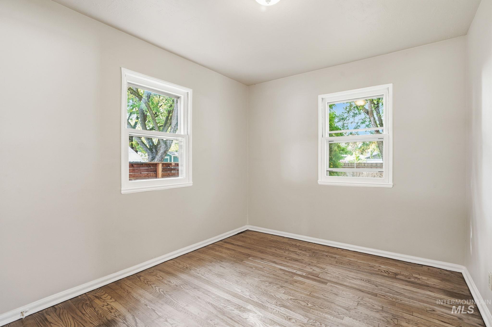 Unfurnished room featuring plenty of natural light and light wood-type flooring
