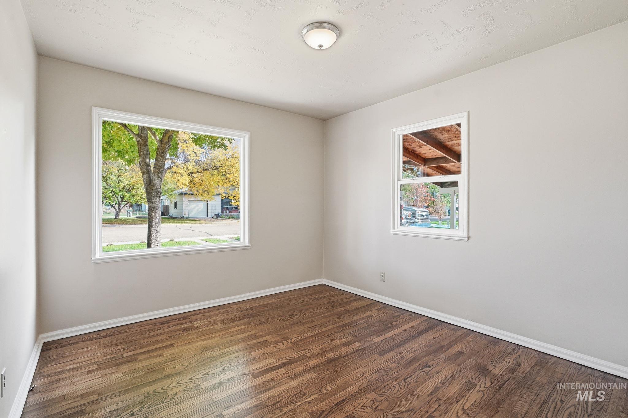 Spare room with wood finished floors and baseboards