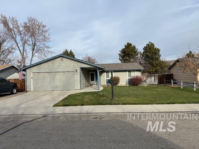 Ranch-style house featuring concrete driveway and a garage