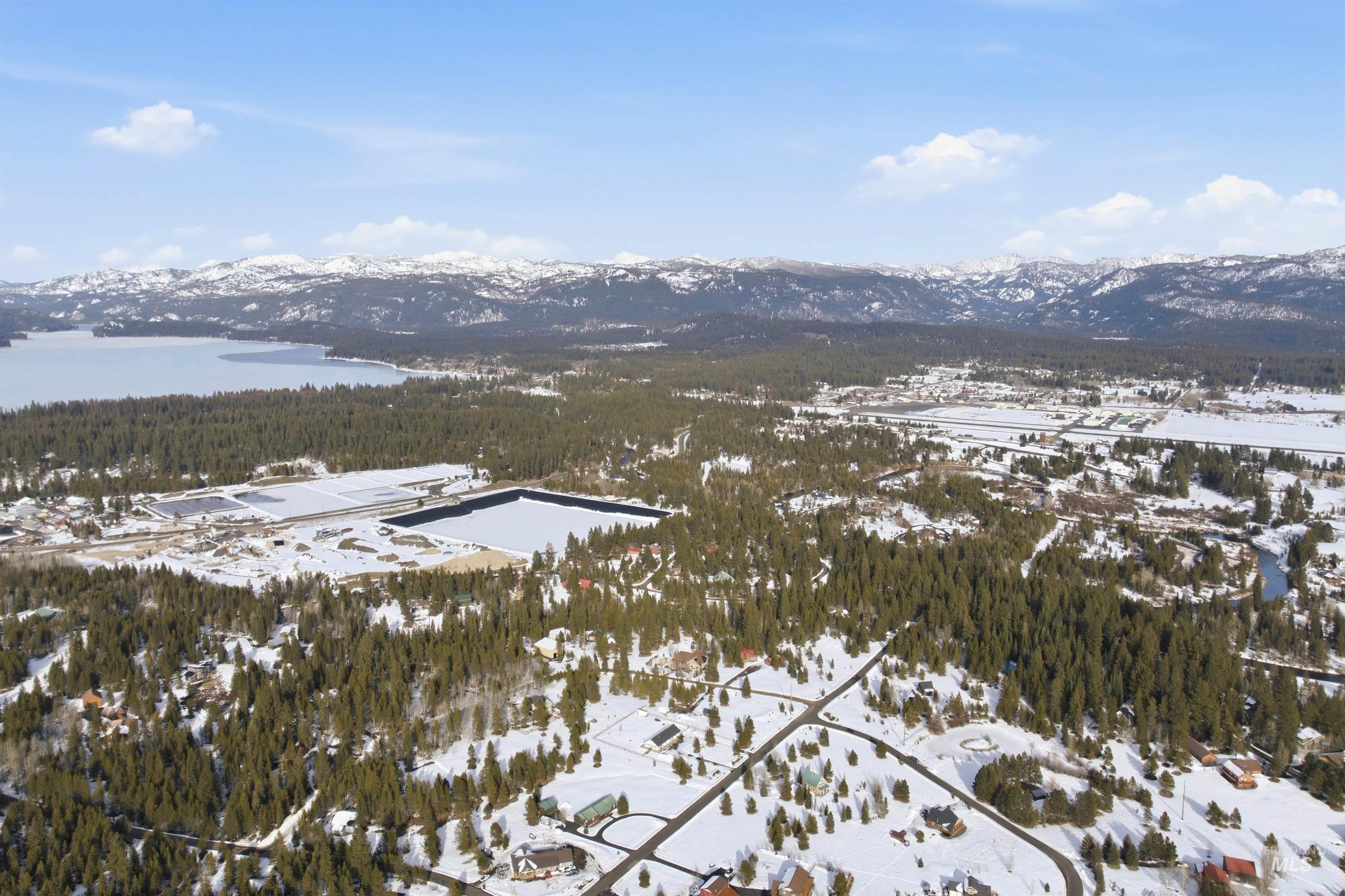 Snowy aerial view featuring a mountain view and a forest view