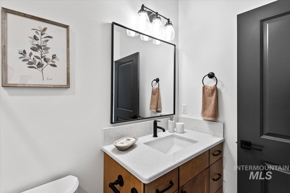 Half bathroom with vanity and toilet
