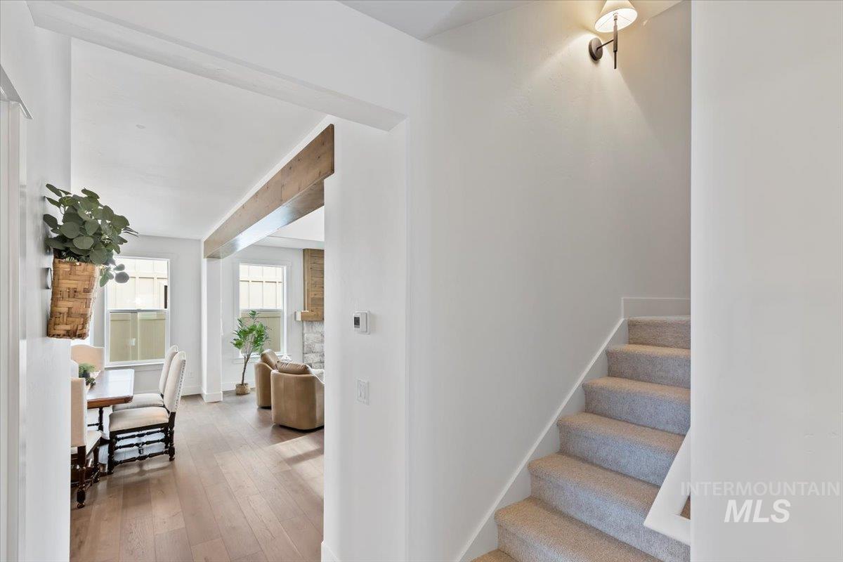 Stairway with wood-type flooring and baseboards