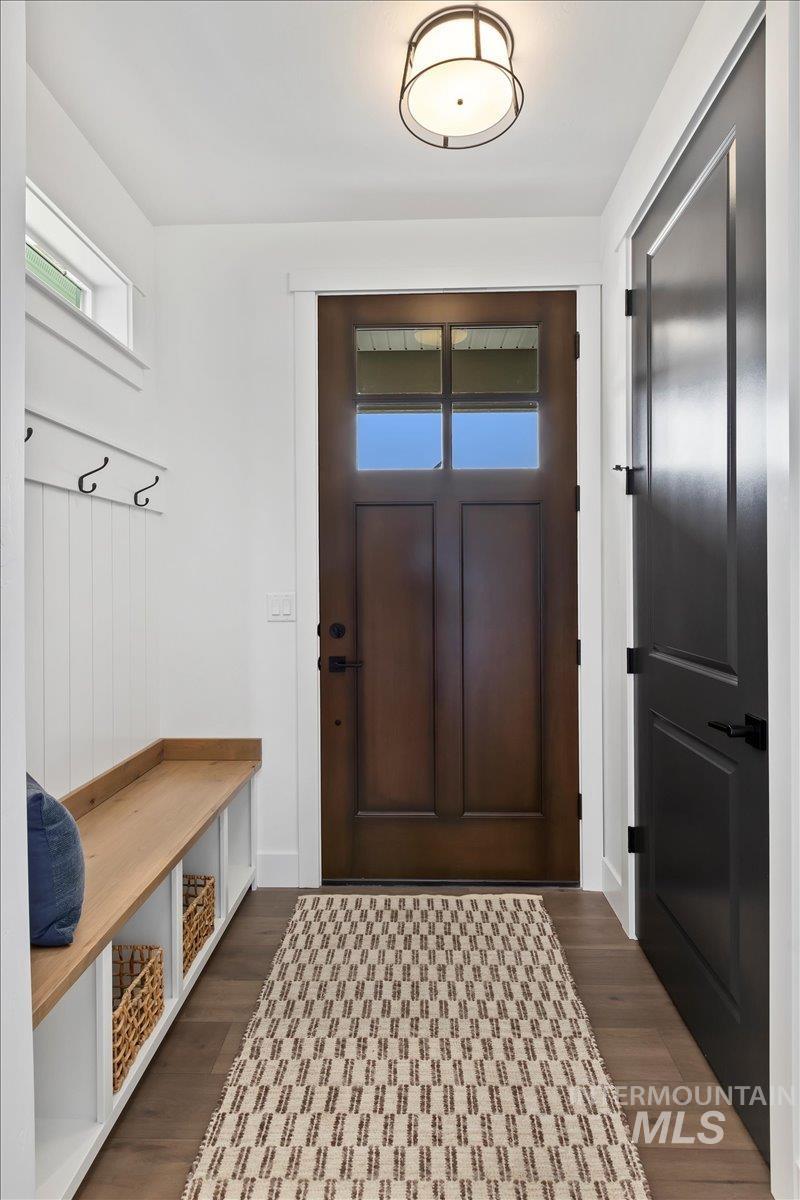 Mudroom with dark wood finished floors