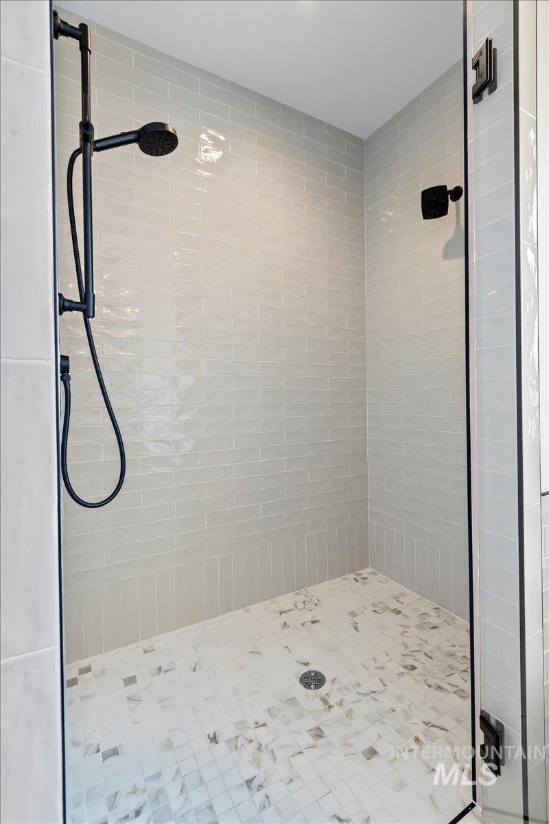 Full bathroom with a shower stall