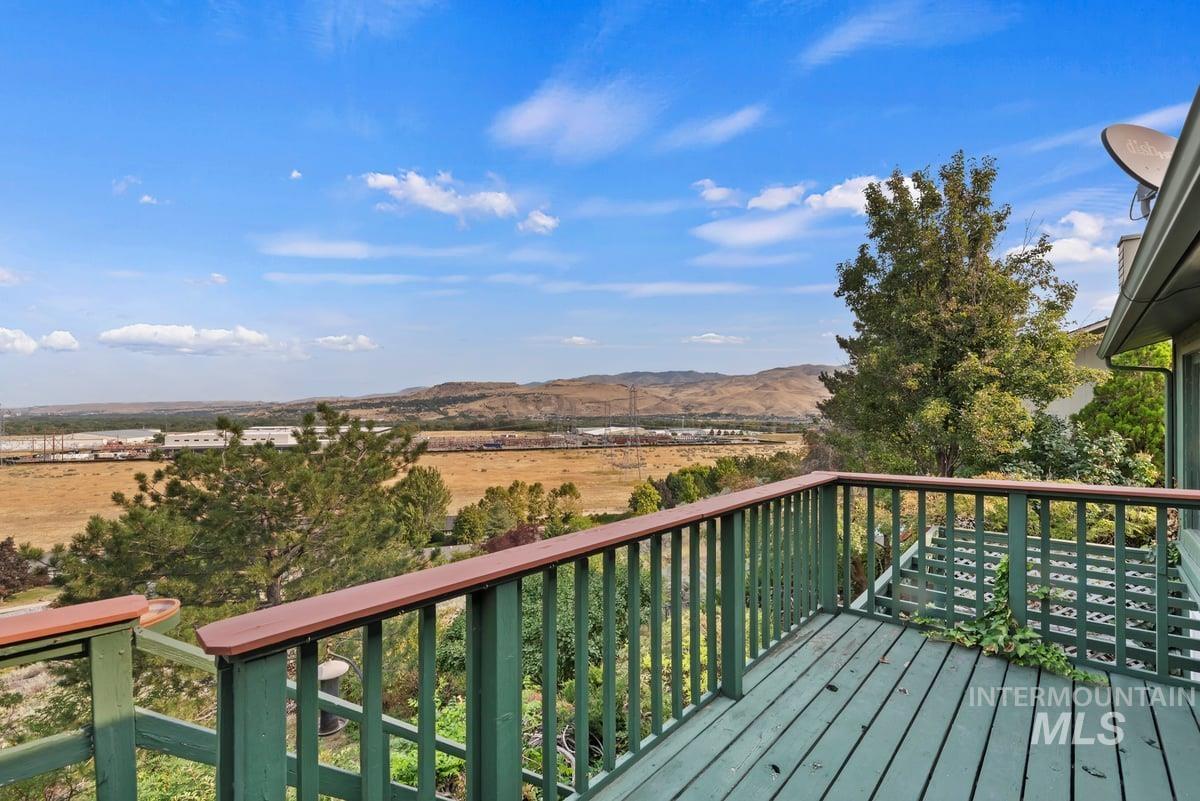 Wooden terrace featuring a mountain view