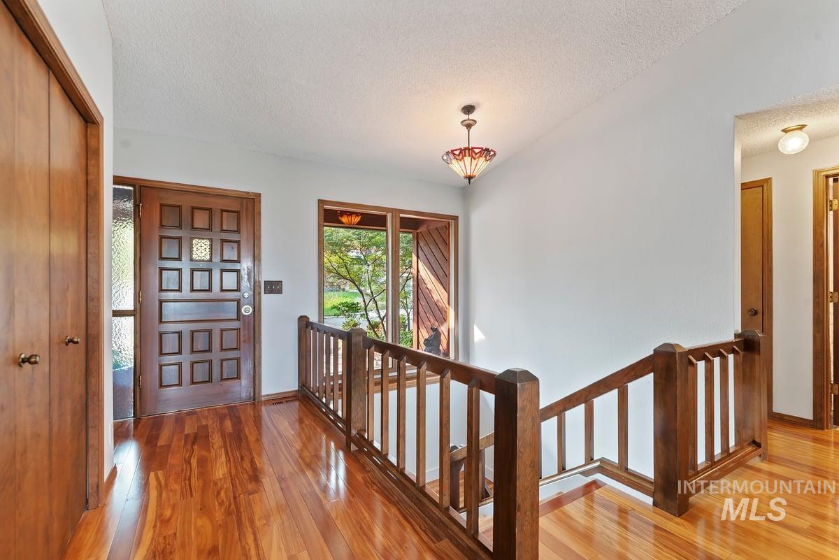 Foyer featuring light wood finished floors and a textured ceiling