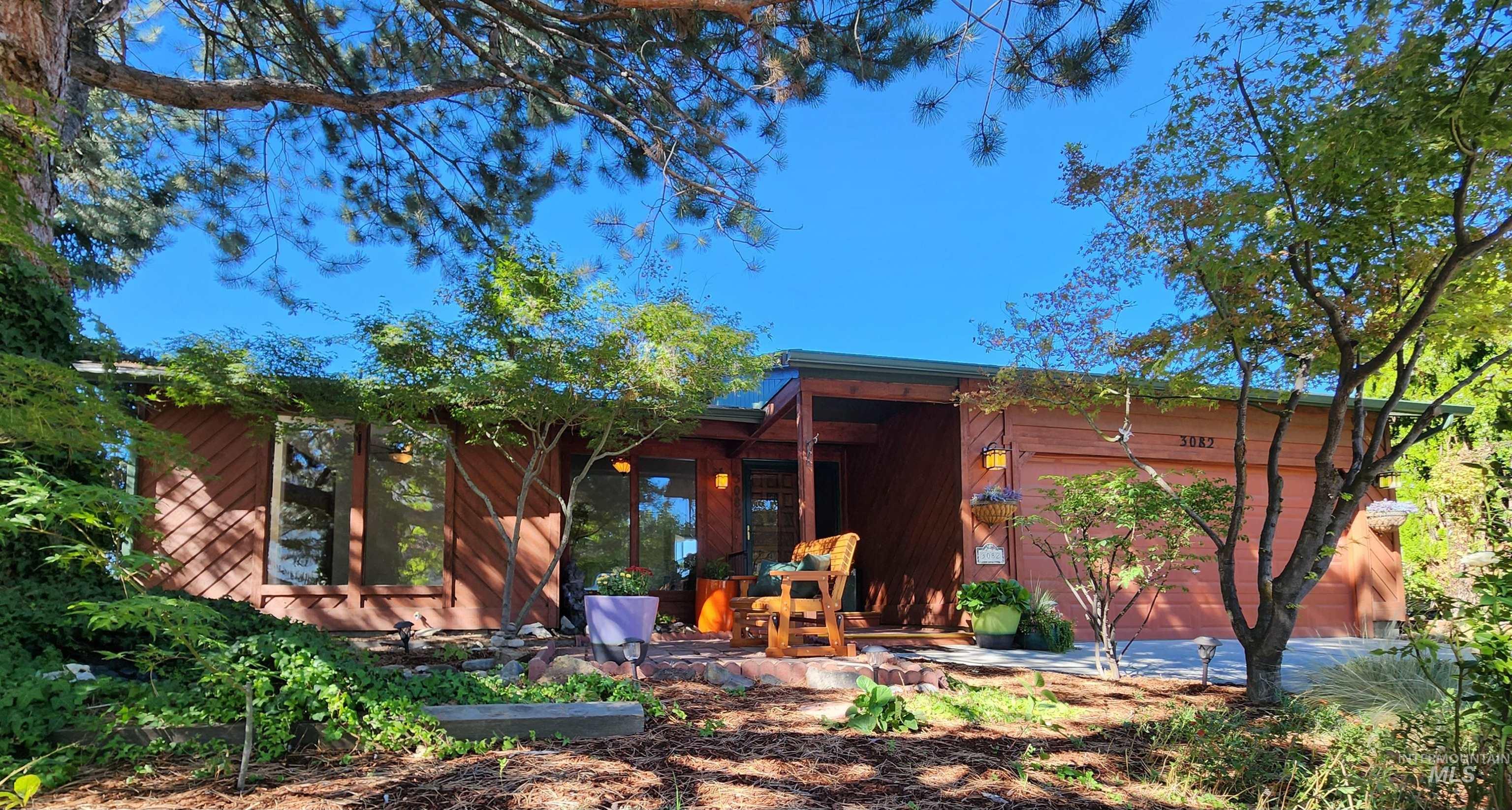 Rear view of house featuring an attached garage and a patio area