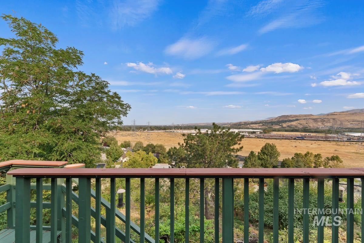 Balcony with a view of rural / pastoral area and a mountain view