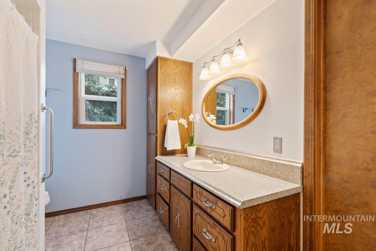 Bathroom with vanity and light tile patterned flooring
