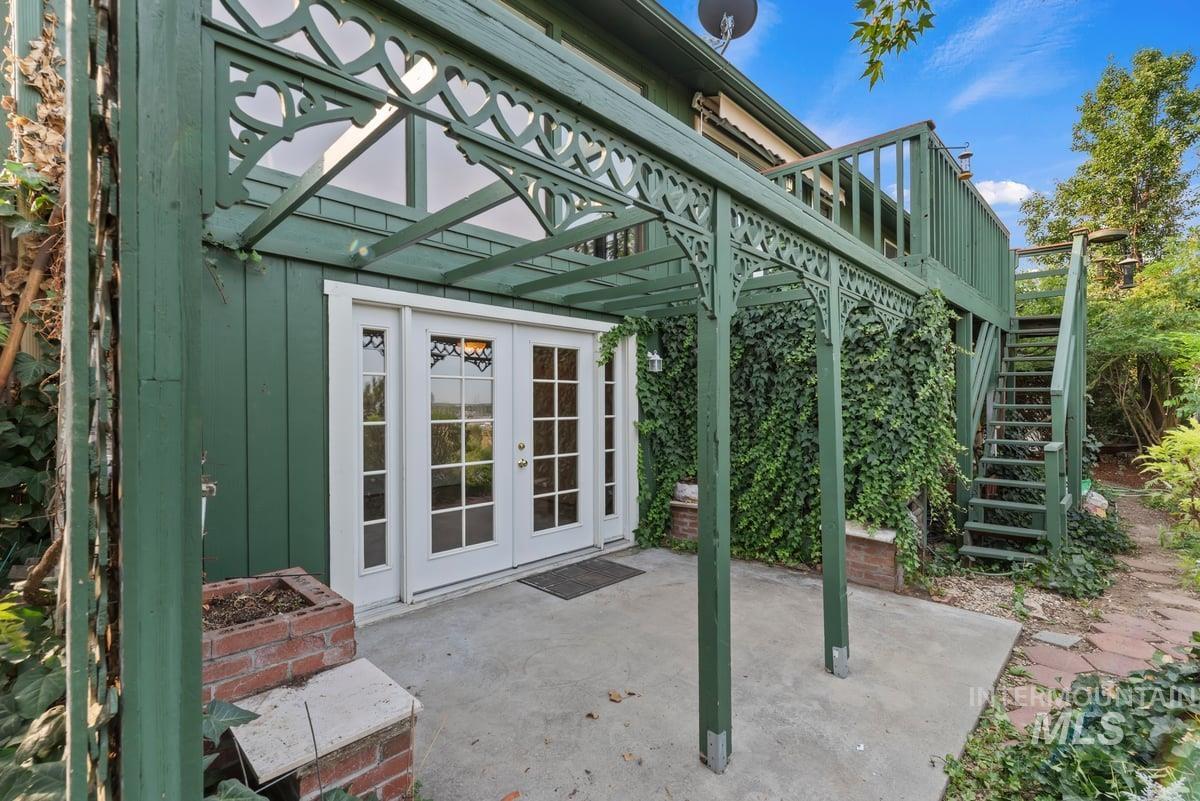 View of patio / terrace featuring stairs, french doors, and a deck