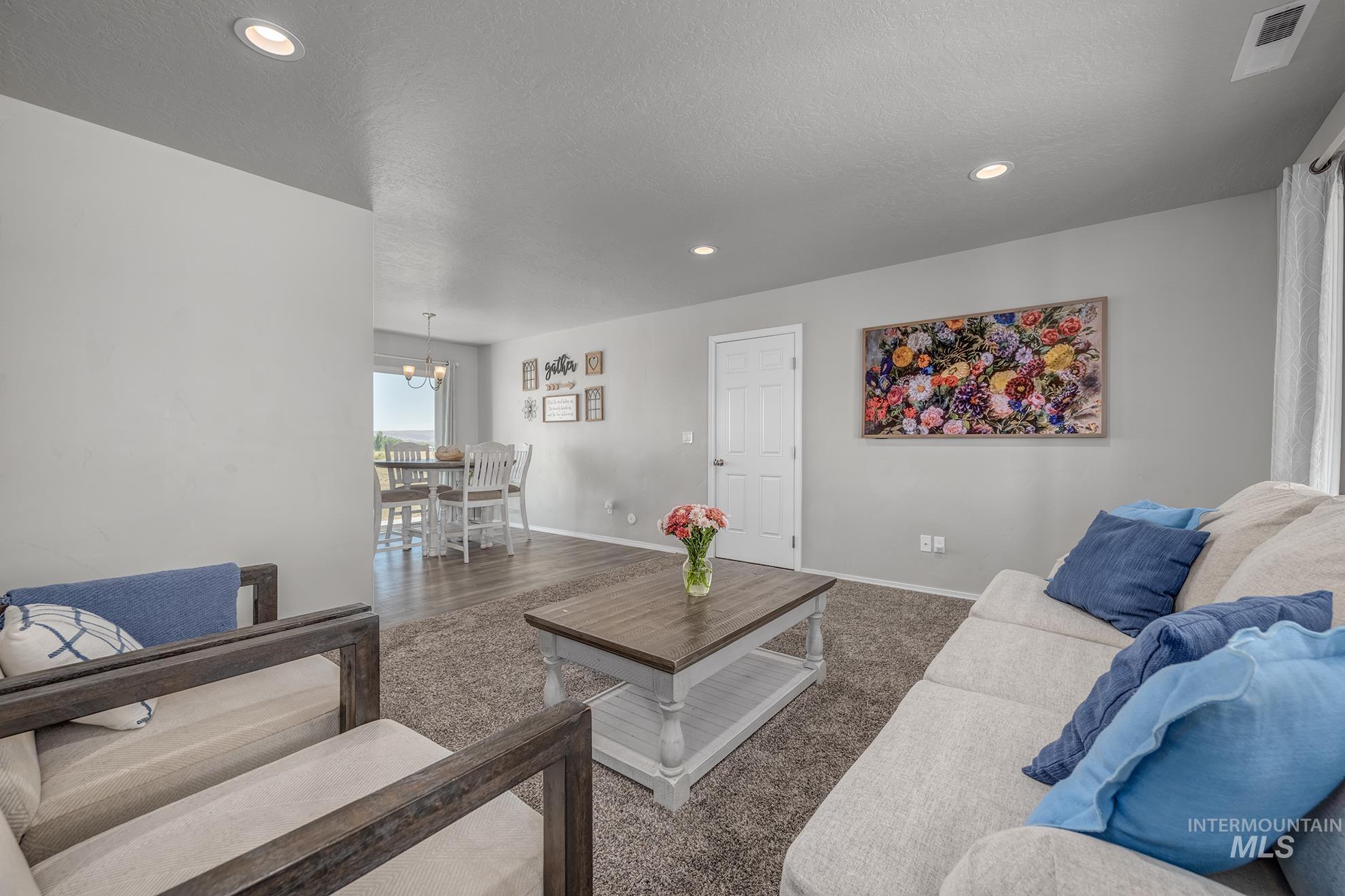 Living area with neutral wall tones and recessed lighting