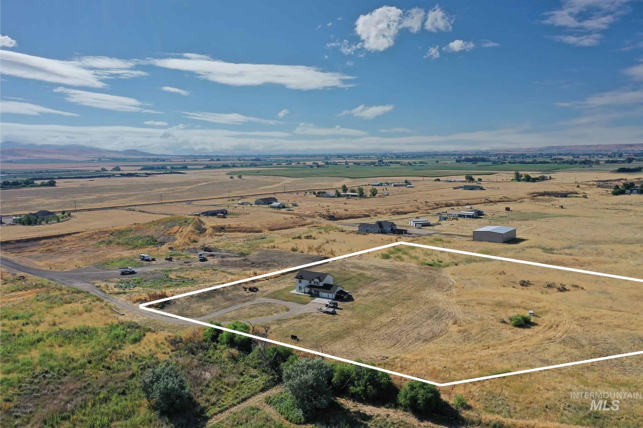 Expansive rural property featuring a single-family residence, substantial open land, and partial mountain scenery