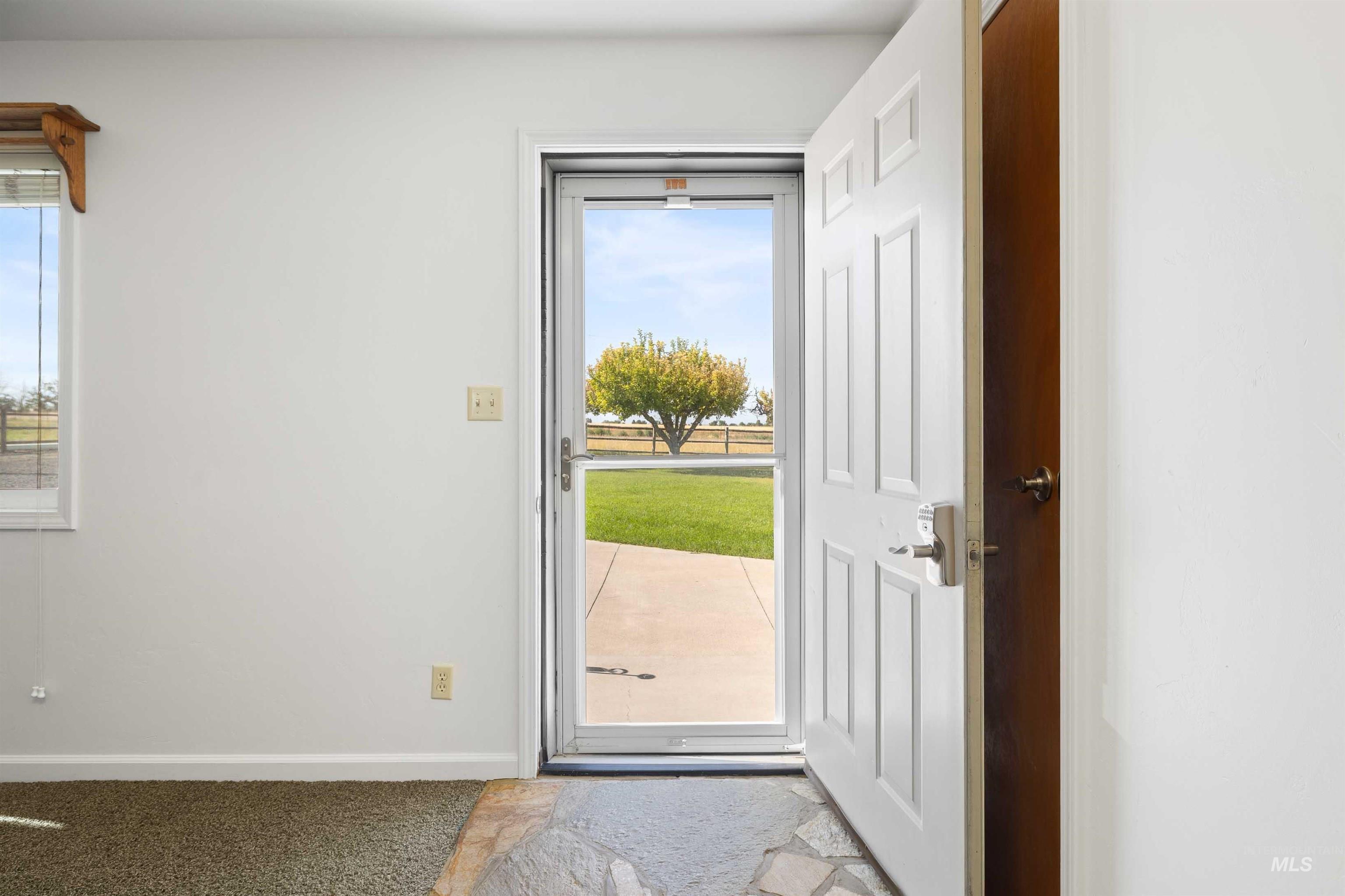Entryway with baseboards and carpet flooring