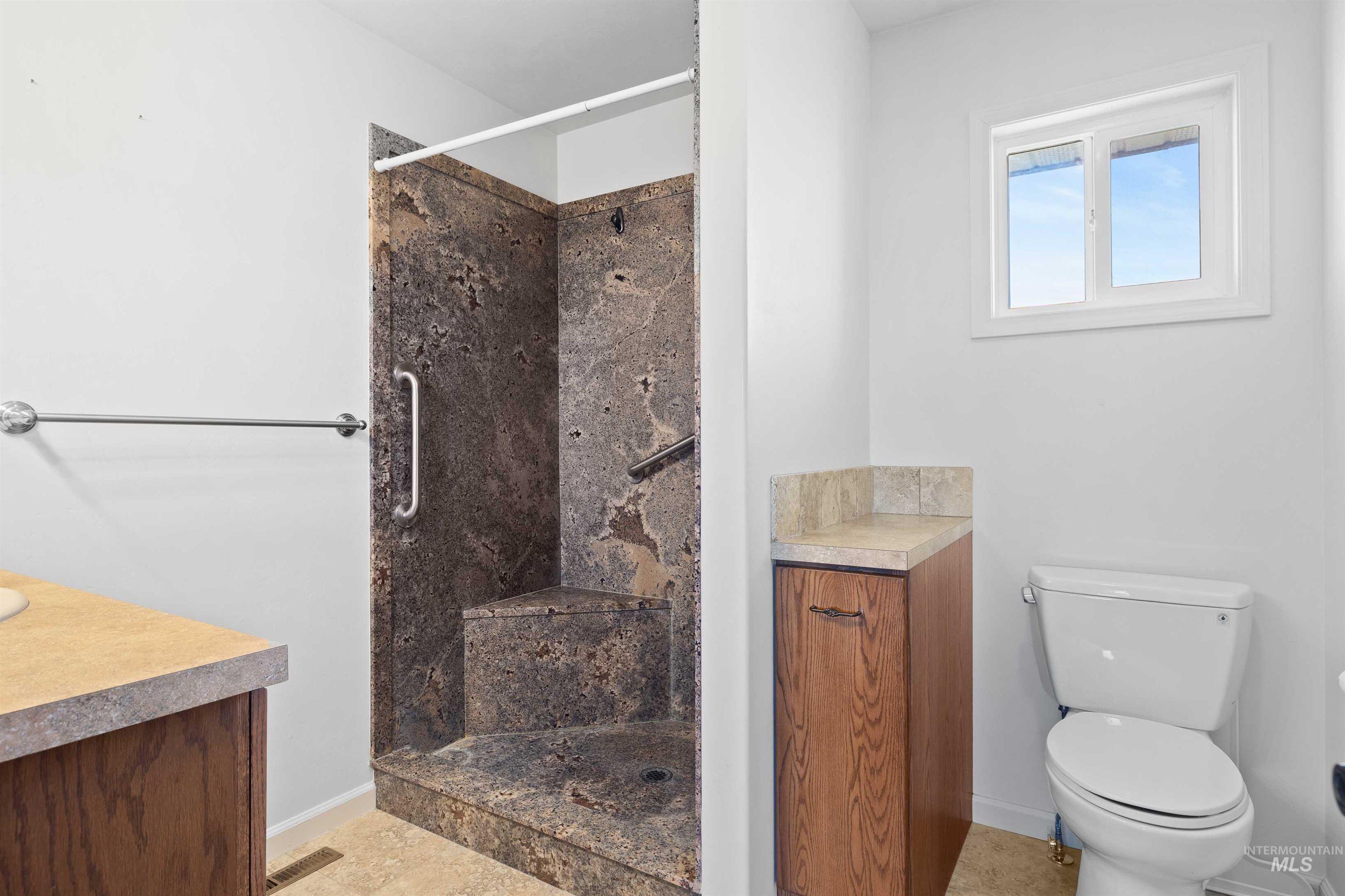 Full bathroom featuring vanity and a tile shower