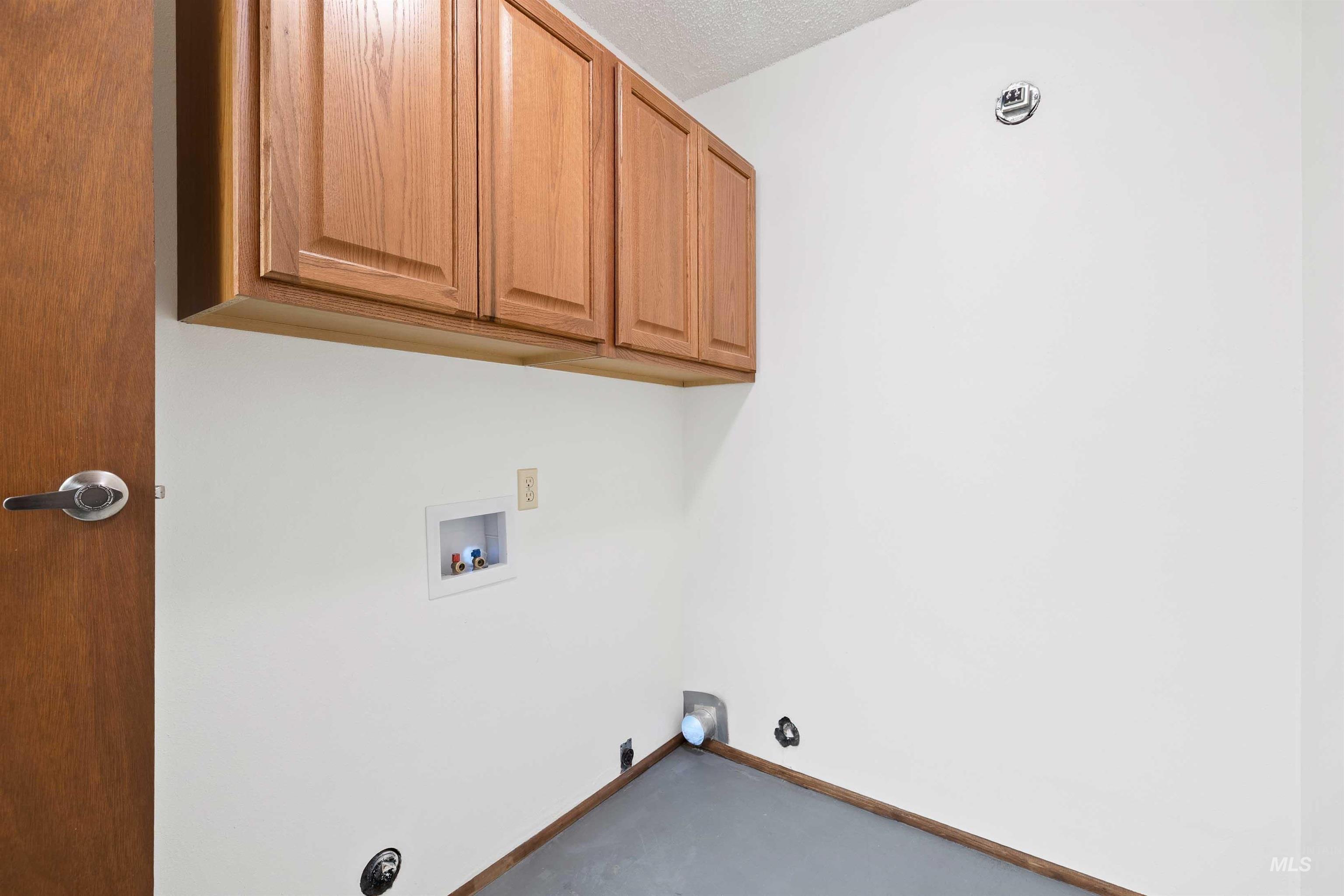 Laundry area with hookup for a washing machine, hookup for a gas dryer, and cabinet space