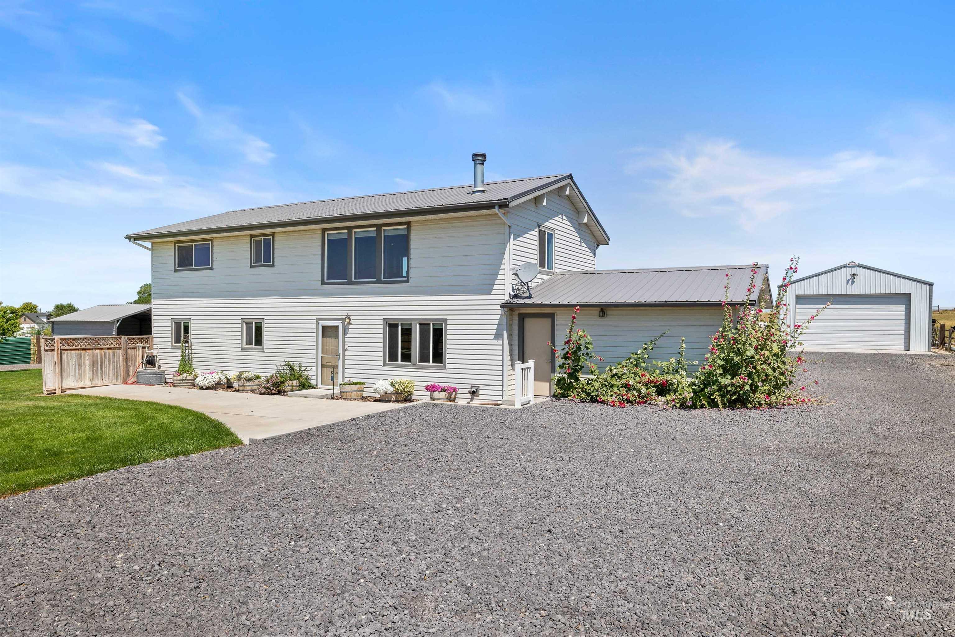 View of front of house with an outbuilding and a detached garage