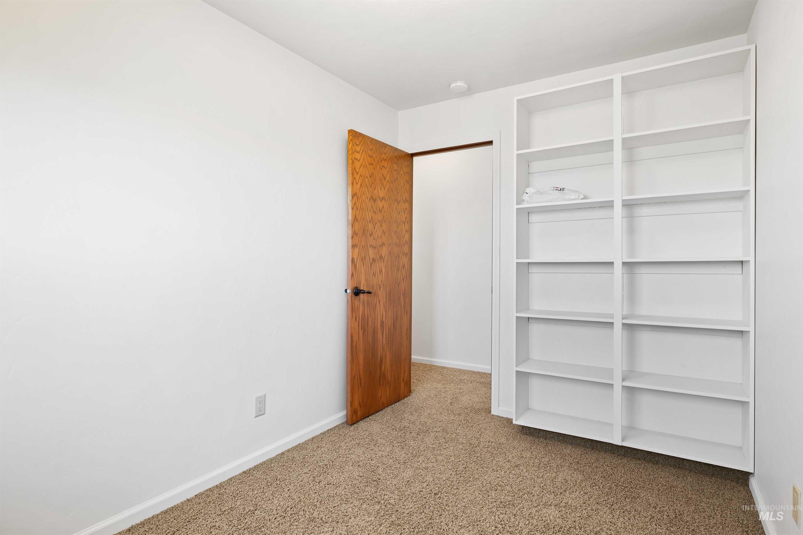 Unfurnished bedroom featuring carpet floors and a closet