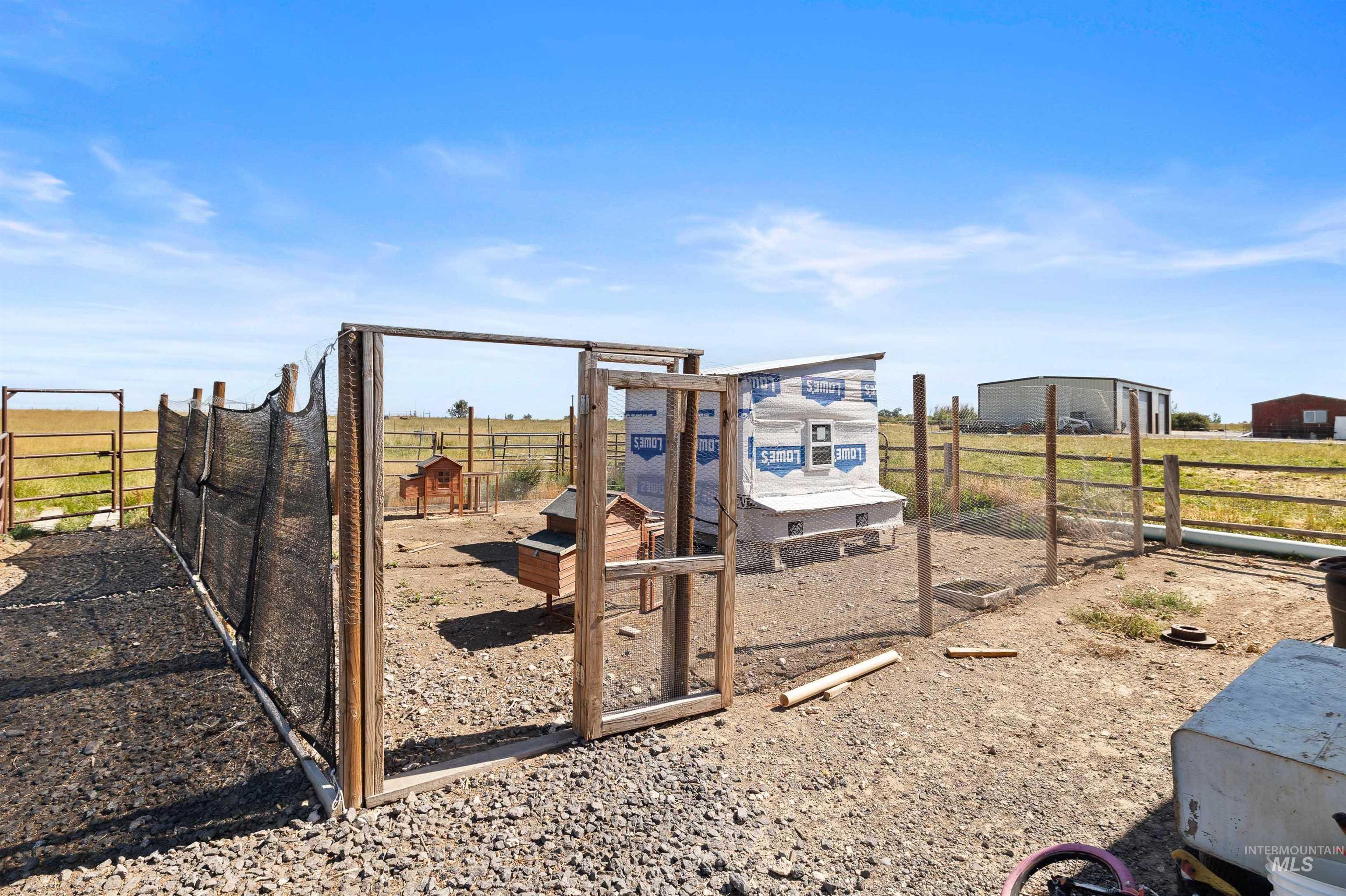 View of play area with exterior structure and an outbuilding