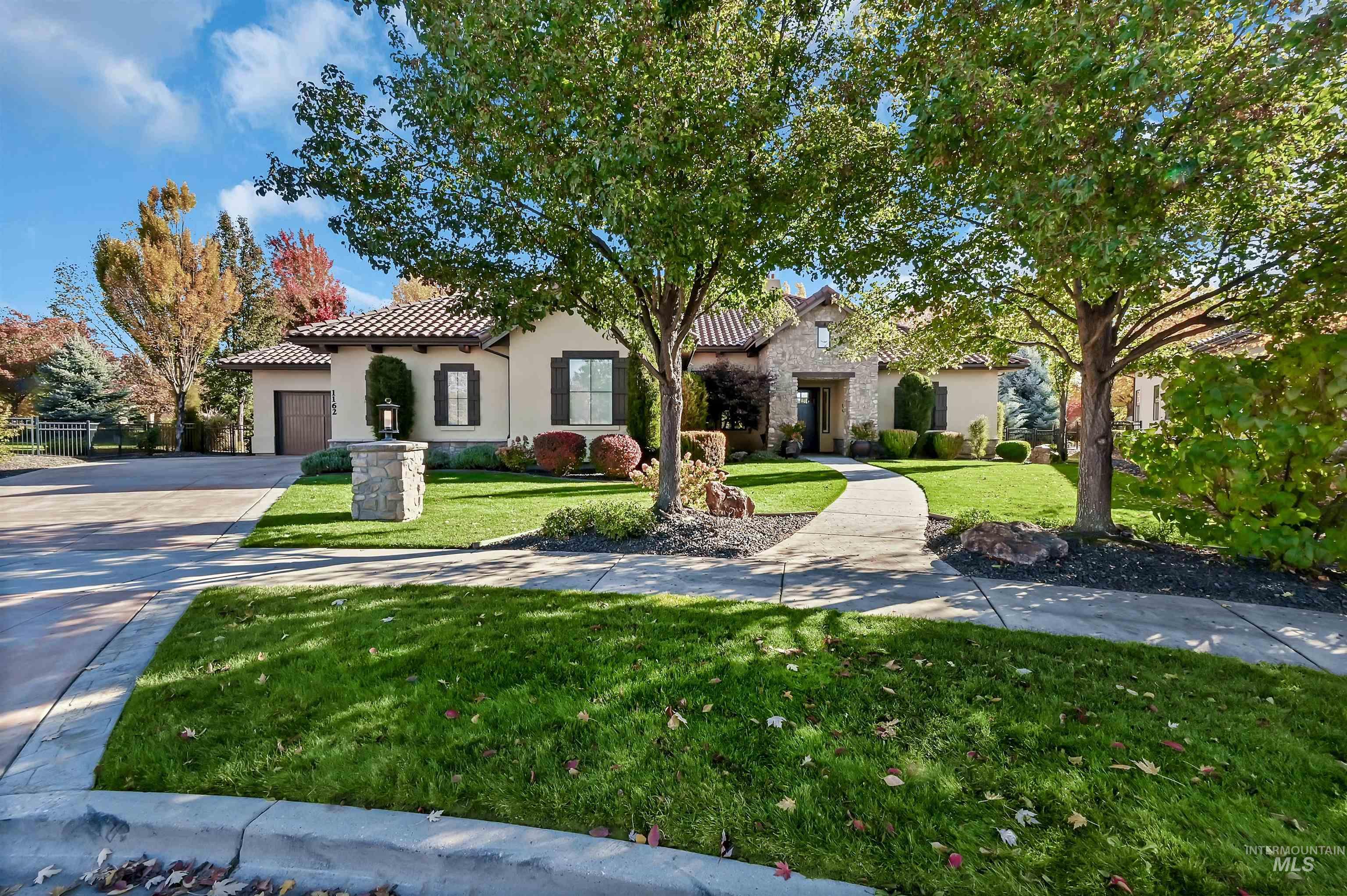 Mediterranean / spanish-style home with concrete driveway, a front yard, stucco siding, a garage, and a tiled roof