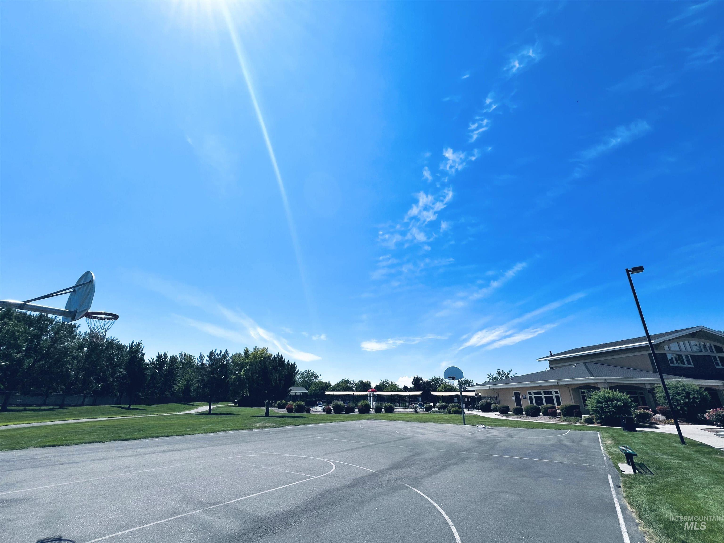View of basketball court featuring community basketball court and a yard